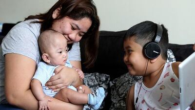 Nine-month-old Nicholas Sacramento with his mother Suzie and his 9 year old brother Amiel at their home in Dubai. Satish Kumar / The National