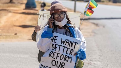 Zimbabwean novelist Tsitsi Dangarembga holds a placard during an anti-corruption protest march in Zimbabwe prior to her arrest. AFP / ZINYANGE AUNTONY