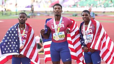 Bronze medalist Trayvon Bromell, gold medalist Fred Kerley, and silver medalist Marvin Bracy pose after competing in the men's 100m at the World Athletics Championships. Getty