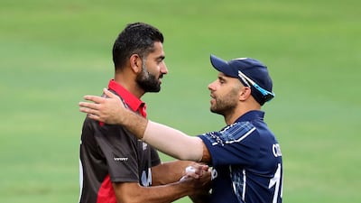 UAE captain Ahmed Raza shakes hands with a Scotland player during a tri-series match. Whiteoak / The National