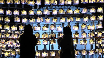 Visitors pray in front of lanterns with the New Year's wishes of Buddhists attached, at Jogyesa Temple in central Seoul, South Korea. AFP