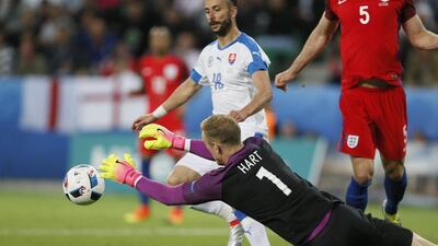 England goalkeeper Joe Hart dives low to collect the ball ahead of and Dusan Svento of Slovakia. Sergey Dolzhenko / EPA