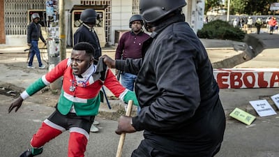 A protester is arrested by plainclothes Kenyan police officers. AFP