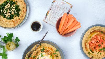 The gourmet side dishes include homemade pickles, aquafaba and garlic confit.