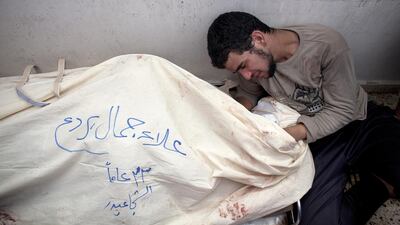 A man mourns over his dead relative at the morgue in Shifa Hospital in Gaza City. At least 66 Palestinians were killed in the Shujaieh neighbourhood, which was heavily shelled by Israel during fighting, in Gaza City on July 20, 2014. Heidi Levine for The National