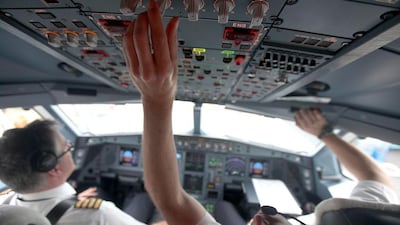 The Etihad captains Francois Lacombe, left, and Oliver Iffert perform preflight checks before a flight from France to Abu Dhabi. Sammy Dallal / The National