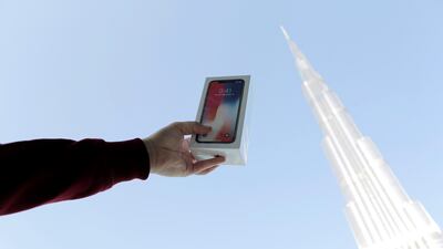 A customer takes a photo of the Burj Khalifa with the new iPhone X. Mahmoud Khaled / EPA