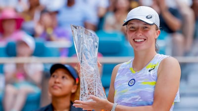 Iga Swiatek holds the Butch Buchholz Trophy after defeating Naomi Osaka in the Miami Open final. EPA