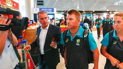 Australian cricket player David Warner, centre, departs from Cape Town International airport. Nic Bothma / EPA