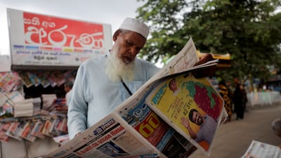 A man reads a newspaper featuring news of Anura Kumara Dissanayake's victory in Sri Lanka's presidential election. Reuters