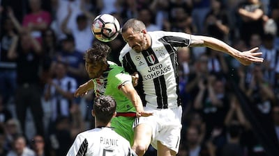 Juventus's Leonardo Bonucci, right, jumps for the ball with Crotone's Diego Falcinelli. Antonio Calanni / AP Photo