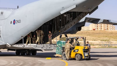 UK military personnel load the aid on to an A400M Atlas aircraft.