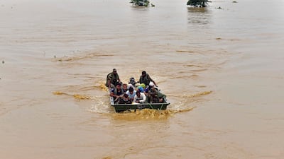 Army soldiers evacuate villagers after heavy rains in the Hojai district of Assam. AFP