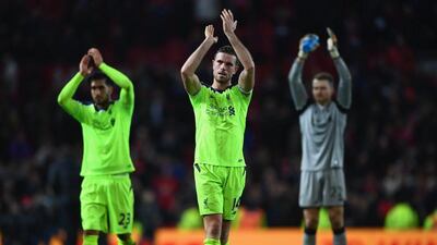 Emre Can, Jordan Henderson and Simon Mignolet of Liverpool applaud the travelling fans after drawing Manchester United 1-1 at Old Trafford on January 15, 2017 in Manchester, England. Laurence Griffiths / Getty Images