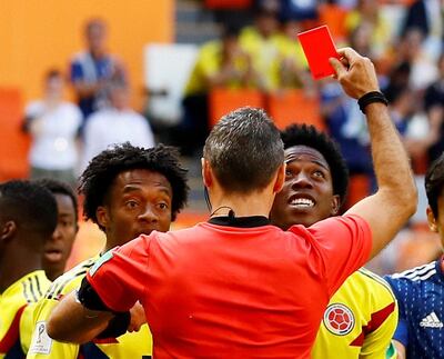 Colombia's Carlos Sanchez, right, is sent off during the group match against Japan for deliberate handball by referee Damir Skomina. Jason Cairnduff / Reuters