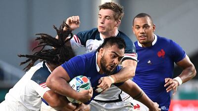 France's prop Emerick Setiano (R) is tackled by US fly-half AJ MacGinty (C) and US hooker Joseph Taufete'e (L) during the Japan 2019 Rugby World Cup Pool C match between France and the United States at the Fukuoka Hakatanomori Stadium in Fukuoka. AFP