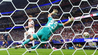 England's Anthony Gordon scores past Argentina goalkeeper Emiliano Martinez. Reuters