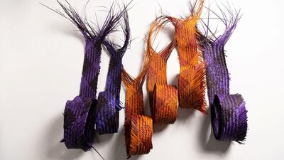 The traditional safeefah, or palm-frond weaving, technique has been braided with strands of camel leather to produce sculptural handbags. Courtesy Irthi Contemporary Crafts Council