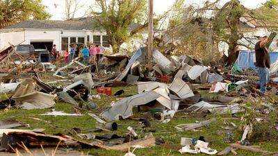 Oklahoma residents survey the damage in a neighbourhood struck by a tornado on Sunday evening, April 27, 2014. Gary Crow / Tulsa World / AP Photo