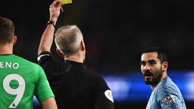 Ilkay Gundogan of Manchester City reacts as he is shown a yellow card by referee Martin Atkinson. Getty Images