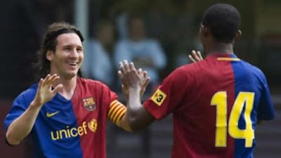 Samuel Eto'o congratulates Barcelona teammate Lionel Messi after he scored his hat-trick in a pre-Season Friendly against Dundee United.