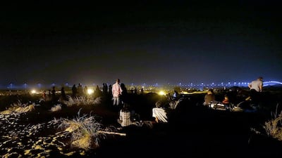 UAE residents wait on the outskirts near Bab Al Shams resort to catch a glimpse of the predicted meteor shower in Dubai. Satish Kumar / The National