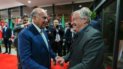 Iraqi Foreign Minister Fuad Hussein, left, welcomes UN Secretary General Antonio Guterres as he arrives to attend the Arab League Summit in Baghdad. AFP