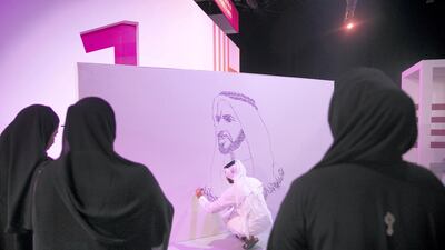 An artist draws a caligraphic mural of Sheikh Zayed at during the Mohammed Bin Zayed Council for Future Generations sessions.