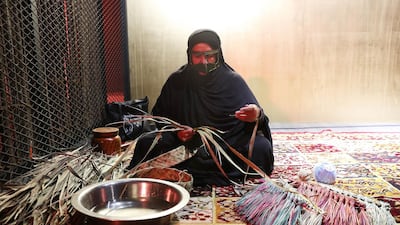 Making a broom with palm leaves during the Al Shindagha Days festival held at Al Shindagha Heritage District in Dubai. Pawan Singh / The National