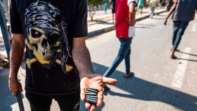 An Iraqi protester holds out spent bullet casings at a demonstration in the southern port of Umm Qasr after security forces attempted to break up crowds blocking the road to the port. AFP