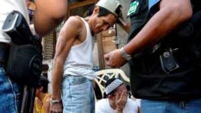 Under arrest: this man was caught with illegal drug paraphernalia during a Philippines Drug Enforcement Agency raid in Manila.