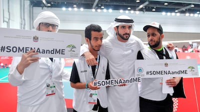 Sheikh Hamdan poses with volunteers at the Special Olympic Mena Games on Monday. Wam
