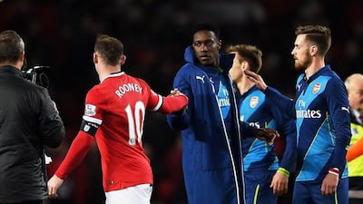 Former teammates Wayne Rooney of Manchester United and Danny Welbeck of Arsenal acknowledge one another after their FA Cup quarter-final match on Monday night. Laurence Griffiths / Getty Images