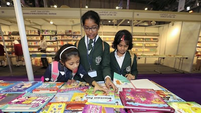 Children look at their favourite books at the Sharjah children's reading festival.