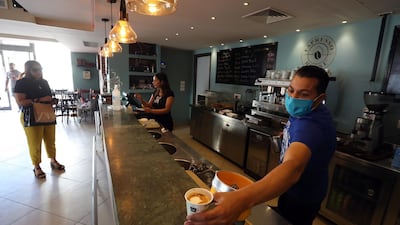 A waiter prepares coffee at a cafe which reopened for take away only in Tunis, Tunisia. EPA