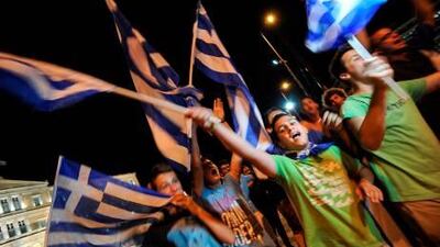 Greek supporters celebrate at the end of the Euro 2012 football match between Greece and Russia in front of their parliament in central Athens, a night before their election day.