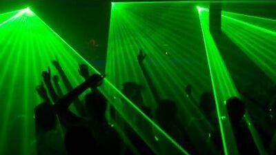 The spirit of disco: House music fans dance along to a laser light show. Getty Images