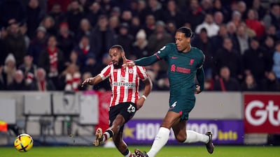 Brentford attacker Bryan Mbeumo shoots at goal under pressure from Liverpool's Virgil van Dijk. PA