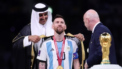 Lionel Messi is presented with a traditional robe by the Emir of Qatar, Sheikh Tamim, after the Fifa World Cup Qatar 2022 Final match between Argentina and France in Lusail City. Getty Images