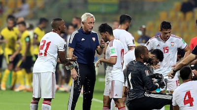 UAE manager Bert van Marwijk speaks to his players during the game. Chris Whiteoak / The National