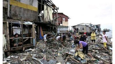 Residents rummage through what is left of their shanties damaged by Typhoon Nesat in Manila yesterday. Bullit Marquez / AP Photo