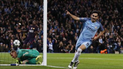 Ilkay Gundogan wheels away in celebration after scoring the equalising goal. Phil Noble / Reuters
