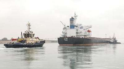 A tugboat pulls the Marshall Islands-flagged bulk carrier M/V Glory in the Suez Canal near al-Qantarah between Port Said and Ismailia. AFP