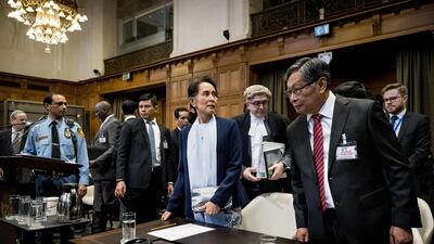 Myanmar's State Counsellor Aung San Suu Kyi (C) stands before the UN's International Court of Justice on December 11, 2019 in the Peace Palace of The Hague, on the second day of her hearing on the Rohingya genocide case. Aung San Suu Kyi appears at the UN's top court today, a day after the former democracy icon was urged to "stop the genocide" against Rohingya Muslims. Once hailed internationally for her defiance of Myanmar's junta, the Nobel peace laureate will this time be on the side of the southeast Asian nation's military when she takes the stand at the International Court of Justice. - Netherlands OUT / AFP / ANP / Koen Van WEEL