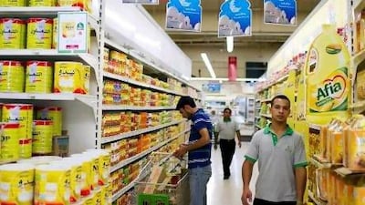 A shopper browses grocery items at Emirates Cooperative Society, where a sign advertises Ramadan pricing, in Al Twar 3 in Dubai.