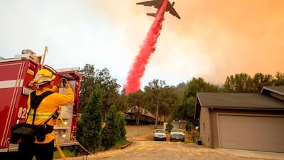 An air tanker drops fire retardant on flames during wildfires in California. Josh Edelson / AFP Photo / July 19, 2017