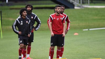 Majed Hassan, second right, and Haboush Saleh, left, wait for instructions