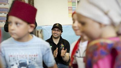 Tariq Al Gurg watches a pre-school performance during a field trip visit to a remote village in Bosnia and Herzegovina as part of his work with Dubai Cares. Razan Alzayani / The National