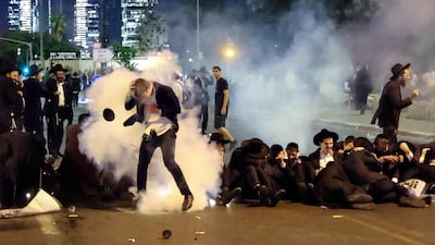 Israeli police use stun grenades to disperse Ultra-Orthodox Jews during a protest against conscription for military service. AFP