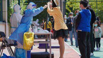 A health worker conducts a swab test for coronavirus during a lockdown in Pudong district in Shanghai, China. AFP